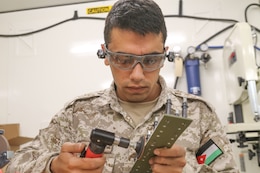 Sgt. Amer Alamaira, Royal Jordanian Air Force, sands down a fabricated sheet metal piece that will be applied to a UH-60 Blackhawk helicopter during a subject matter expert exchange with the U. S. Army’s 1106th Aviation Group at the King Abdullah II Air Base in Amman, Jordan, June 19, 2019.