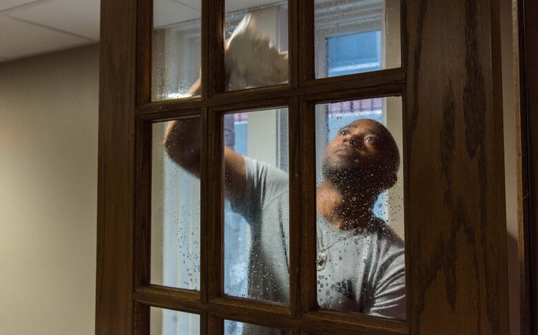 Master Sgt. Johnathan Rias, Air Mobility Command contingency war planning cleans a window inside a Ronald McDonald House in St. Louis