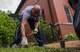 Master Sgt. Johnathan Rias, Air Mobility Command contingency war planning, picks weeds in front of a Ronald McDonald House in St. Louis