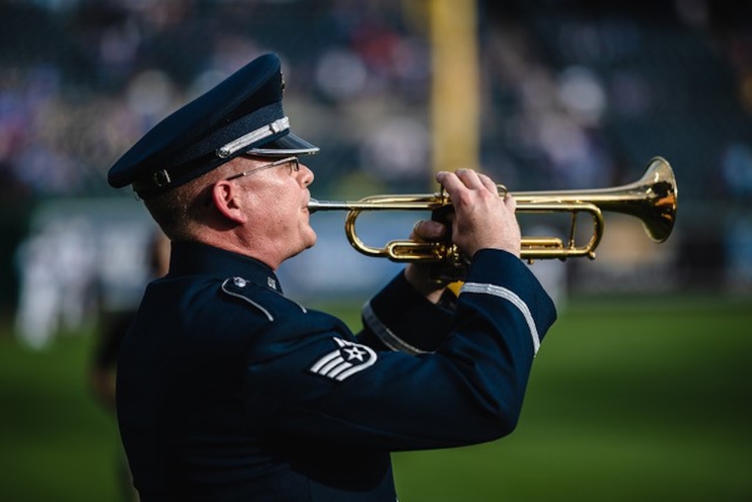 Staff Sergeant Daniel Thrower, trumpeter from the USAF Heartland of Americca Band, performs "Taps" during a 4 July 2019 ceremony at Kauffman Station, Kansas City, Missouri, honoring our fallen service men and women.