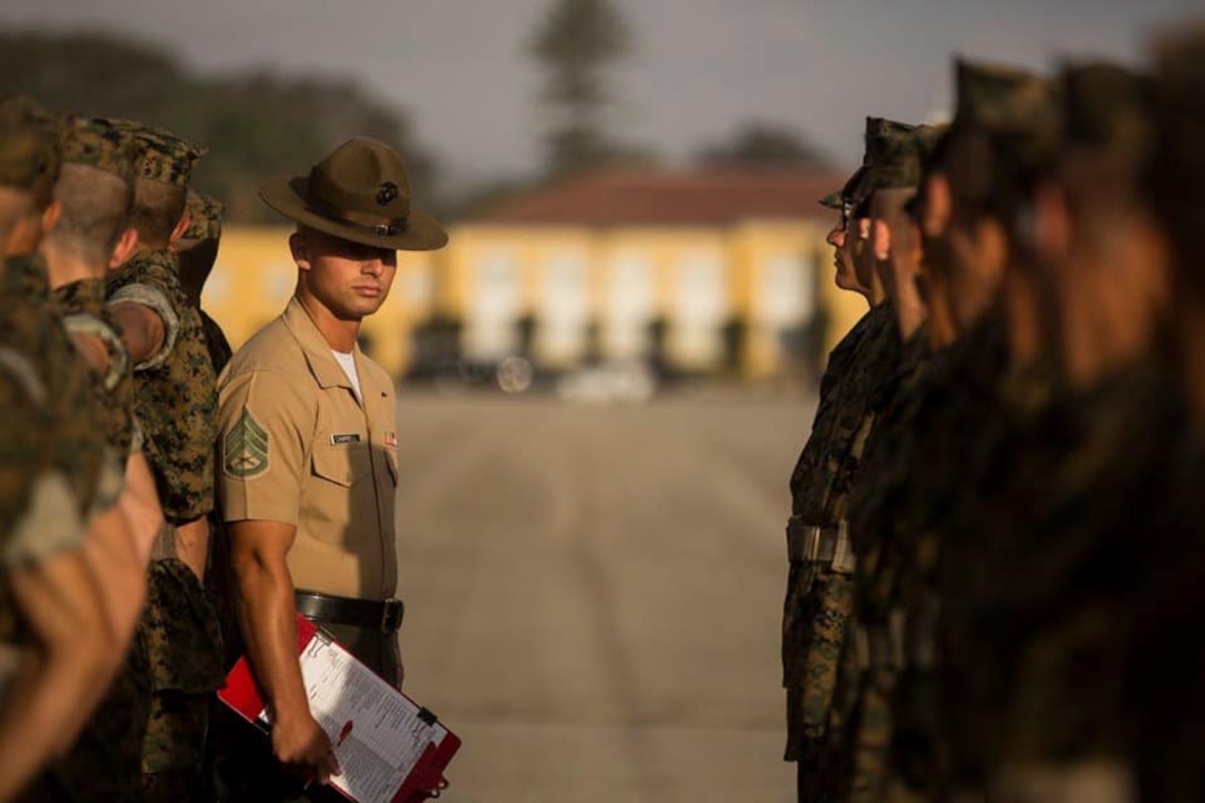 Staff Sgt. Nicolas Campbell, drill master with 1st Recruit Training Battalion, inspects recruits with India Company, 3rd Recruit Training Battalion during a final drill evaluation at Marine Corps Recruit Depot San Diego, June 29.