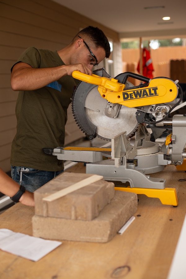 A Marine with Marine Corps Air Station Miramar cuts wood to use as materials for the homes in El Cajon, Calif., June 27. Marines with Single Marine Program (SMP) and Habitat for Humanity volunteers worked together in order to complete the homes that will be going towards refugee families. (U.S. Photo by Lance Cpl. Cheng Chang)