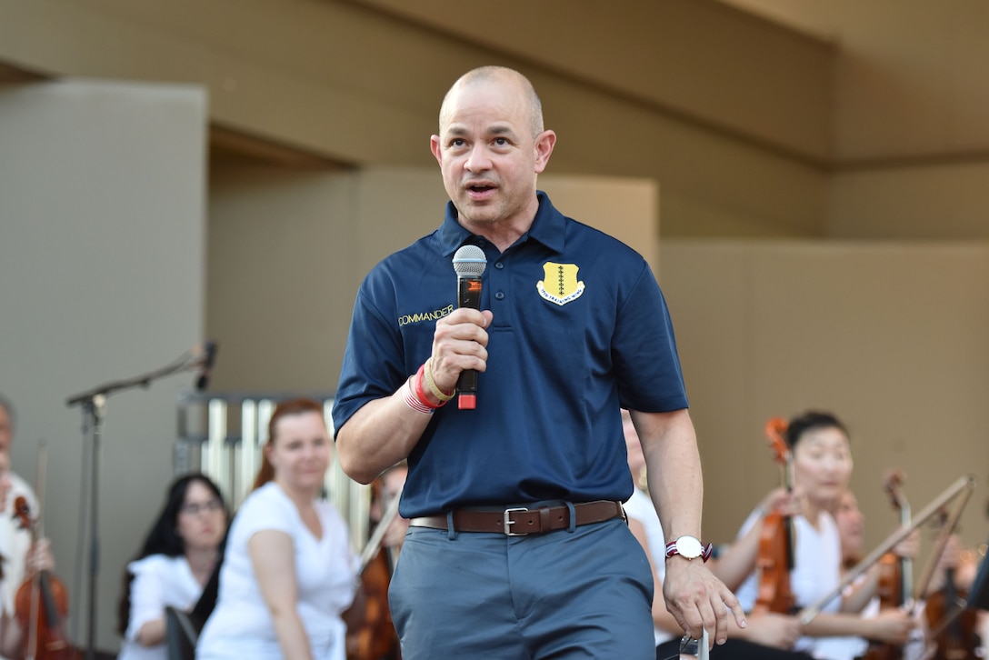 U.S. Air Force Col. Andres Nazario, 17th Training Wing commander, addresses the crowd during the 32nd annual San Angelo Symphony Pops Concert held at the Bill Aylor Sr. Memorial River Stage in San Angelo, Texas, July 3, 2019. Nazario expressed his honor to be the commander of a base he was stationed at two previous times. (U.S. Air Force photo by Senior Airman Seraiah Wolf/Released)