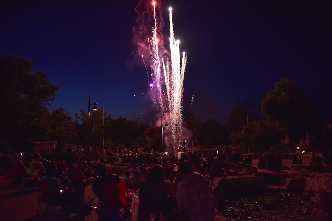 Attendees of the 32nd annual San Angelo Symphony Pops Concert watch as fireworks are launched off Celebration Bridge at the Bill Aylor Sr. Memorial River Stage in San Angelo, Texas, July 3, 2019. The concert included performances by the Community Band, San Angelo Symphony, Goodfellow Honor Guard and a presentation of the 50 state flags. (U.S. Air Force photo by Senior Airman Seraiah Wolf/Released)