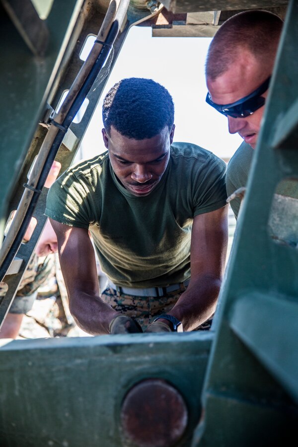 U.S. Marine Corps Lance Cpl. Tyre Reynolds, a motor vehicle operator with Marine Wing Support Squadron (MWSS) 372, Marine Wing Support Group (MWSG) 37, 3rd Marine Aircraft Wing (MAW), removes a winch from a trailer during a Logistics Vehicle System Replacement (LVSR) MKR-16 tractor and M870A2 trailer licensing course at the 25 area motor pool, Marine Corps Base Camp Pendleton, California, July 2, 2019. MWSS-372 is responsible for providing vehicular transportation and support to the various units housed at Marine Corps Air Station Camp Pendleton. (U.S. Marine Corps photo by Cpl. Dylan Chagnon)
