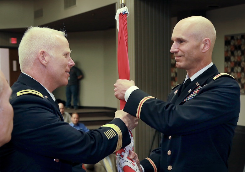 Brigadier Gen. Paul Owen, Southwestern Division Commander, presents the USACE flag to Col. Scott Preston during a change of command ceremony at the Tulsa District, July 8.