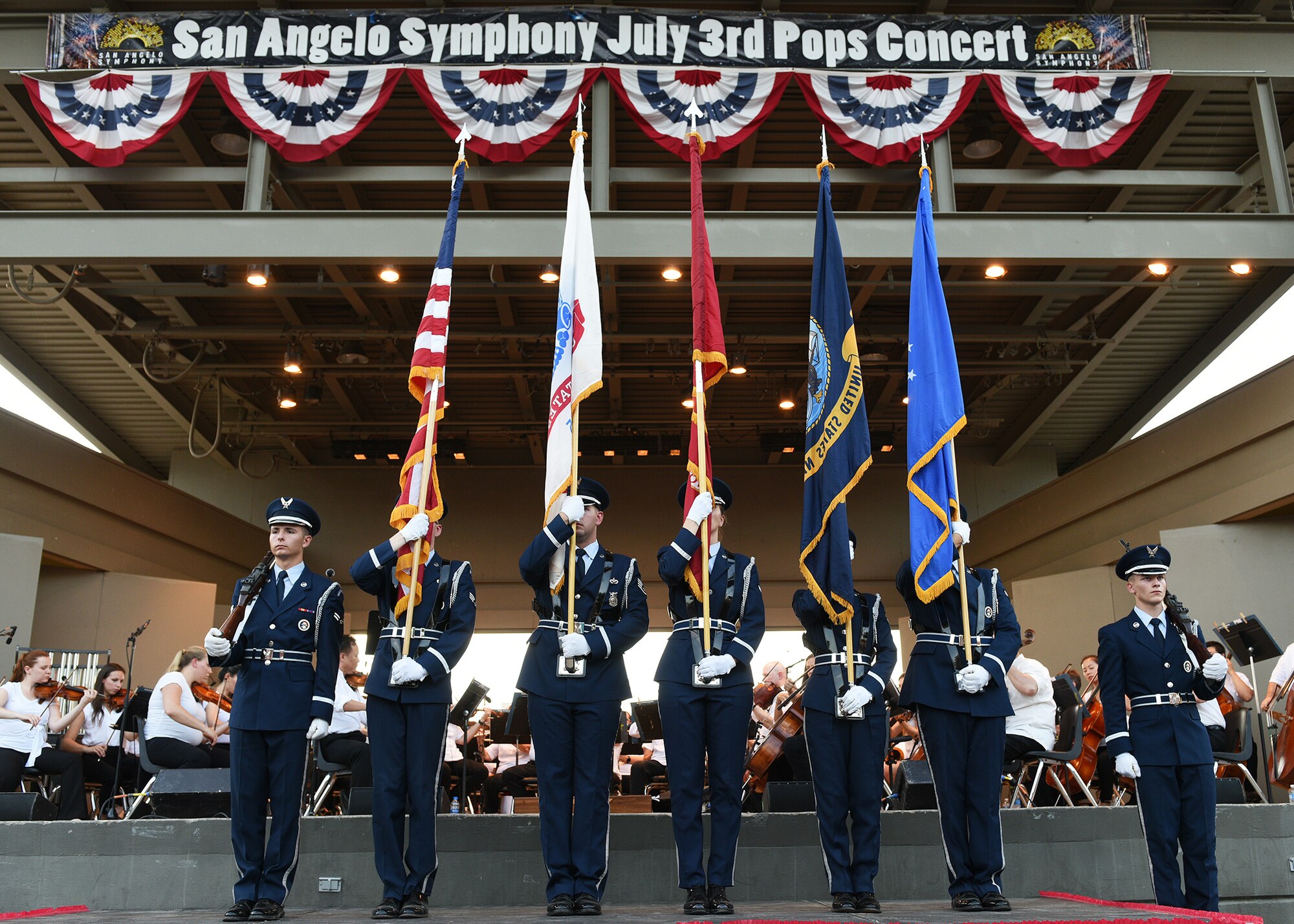 The Goodfellow Air Force Base Honor Guard presents the colors during the 32nd annual San Angelo Symphony Pops Concert at the Bill Aylor Sr. Memorial River Stage in San Angelo, Texas, July 3, 2019. Nearly 100 Goodfellow service members volunteered to support the free concert held as a celebration of Independence Day. (U.S. Air Force photo by Staff Sgt. Chad Warren/Released)
