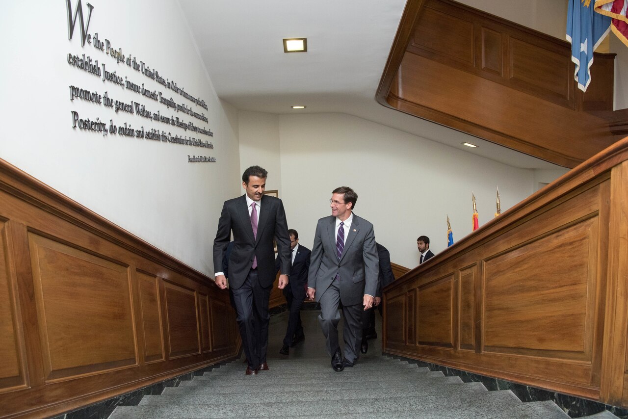 Acting Defense Secretary Dr. Mark T. Esper walks up stairs with another man.