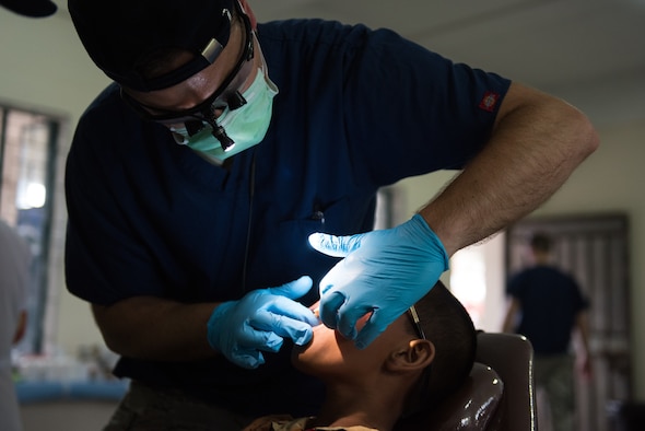U.S. Air Force Maj. Stephen Berg, 374th Dental Squadron dentist, Yokota Air Base, Japan, evaluates a patients’ teeth during a trial day before Pacific Angel 19-1 in Lalmonirhat, Bangladesh, June 22, 2019. The United States, at the invitation of the Government of Bangladesh, provides support by conducting medical, dental, optometry and engineering programs. (U.S. Air Force photo by Staff Sgt. Ramon A. Adelan)