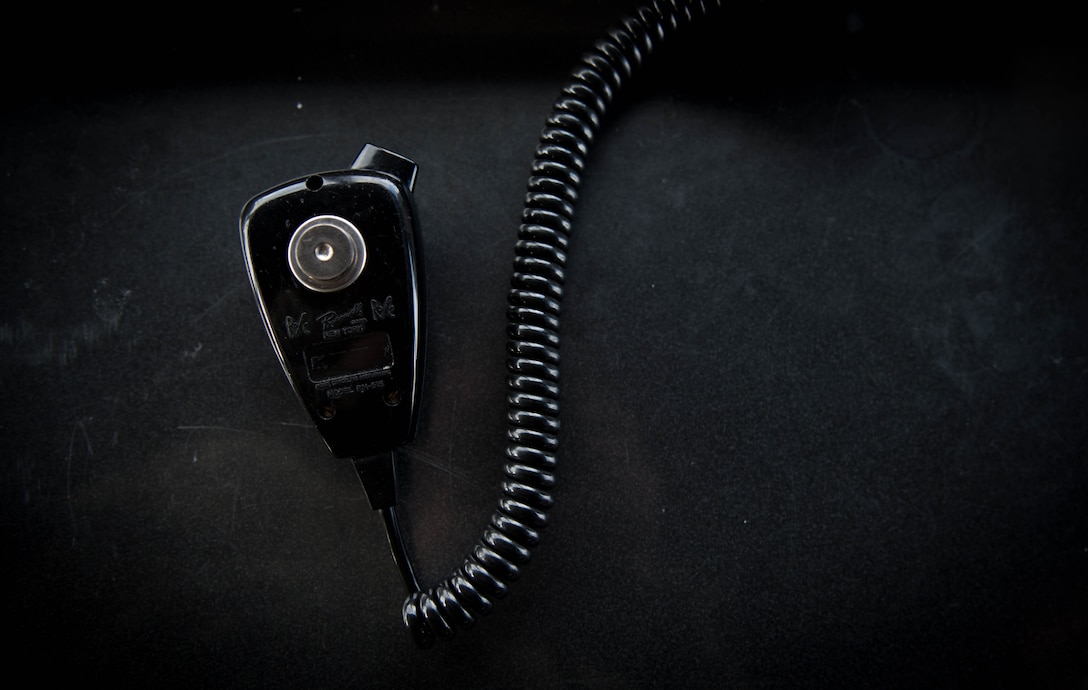 A radio is set on a desk of one of the air traffic controllers in the ATC tower at Scott Air Force Base