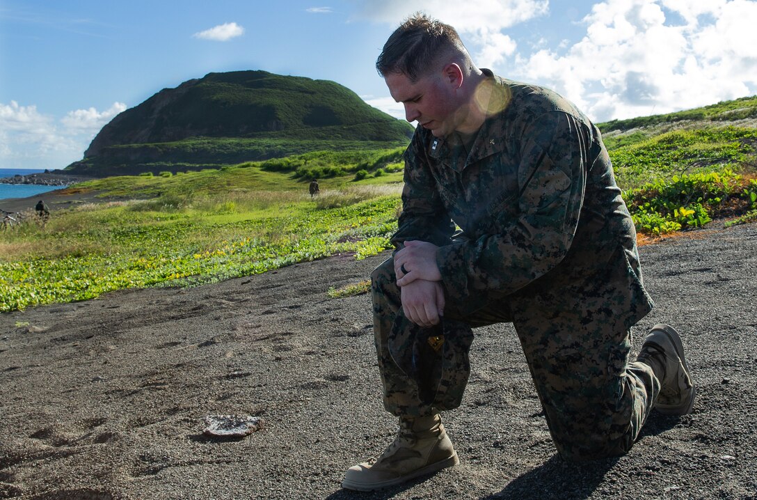 U.S. Navy Lt. Hal Jones prays at the base of Mt. Suribachi, Japan, July 2, 2019. Jones, the Navy Chaplain of 7th Communication Battalion, spoke with the Marines and Sailors and did a moment of silence to honor the service members that died in the Battle of Iwo Jima. (U.S. Marine Corps photo by Lance Cpl. Brienna Tuck)