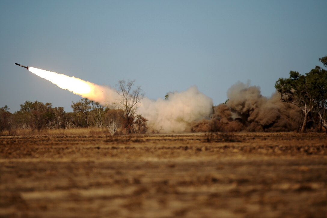 The High Mobility Artillery Rocket System is fired in Bradshaw Field Training Area, Australia July 12, 2015, during Talisman Sabre 15. U.S. Marines with 3rd Battalion, 12th Marine Regiment, out of Okinawa, Japan and 5th Battalion, 11th Marine Regiment, from Marine Corps Base Camp Pendleton, California, trained with the rocket system along with Australian Army soldiers with 8th/12th Regiment, Royal Australian Artillery. Talisman Sabre is a biennial exercise that provides an invaluable opportunity for approximately 30,000 U.S. and Australian service members to conduct operations in a combined, joint and interagency environment that will increase both countries’ ability to plan and execute contingency responses, from combat missions to humanitarian assistance efforts. (U.S. Marine Corps photo by Sgt. Sarah Anderson)