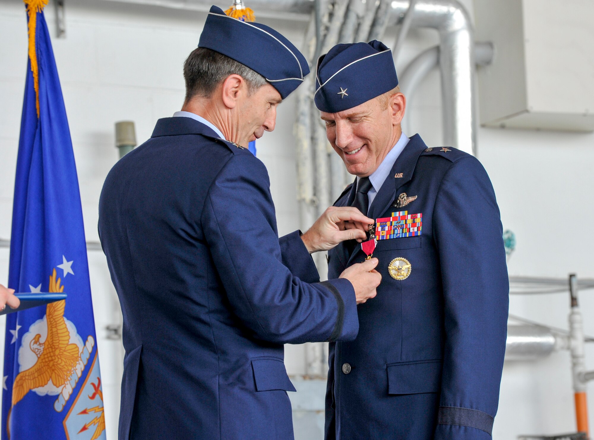 U.S. Air Force Lt. Gen. Kevin Schneider, U.S. Forces Japan and 5th Air Force commander, presents a medel for meritorious service to Brig. Gen. Case Cunningham, former 18th Wing commander, during a change of command ceremony July 8, 2019, at Kadena Air Base, Japan.