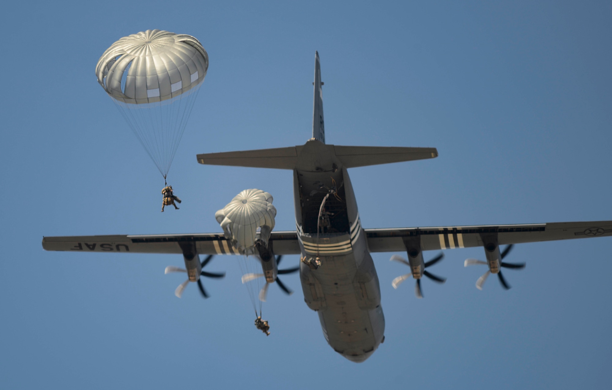 Parachutists assigned to the 435th Air Ground Operation Wing and the 16th Sustainment Brigade jump from a C-130 J Super Hercules aircraft over Ramstein Air Base, Germany, July 2, 2019. The jump allowed personnel to maintain proficiency on static line parachute operations so that they can be ready to support potential contingency operations in Europe.