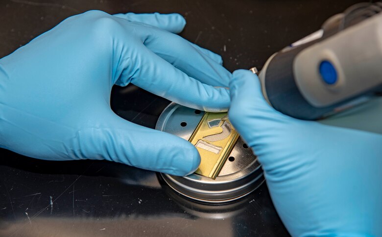 U.S. Army Staff Sgt. Joseph Tutt, AFMES Joint MWD laboratory manager, etches a number into a training aid June 5, 2019. The etched numbers help identify which narcotic is being used in the training aid when it is distributed and recalled by the laboratory. (U.S. Air Force photo by Staff Sgt. Nicole Leidholm)