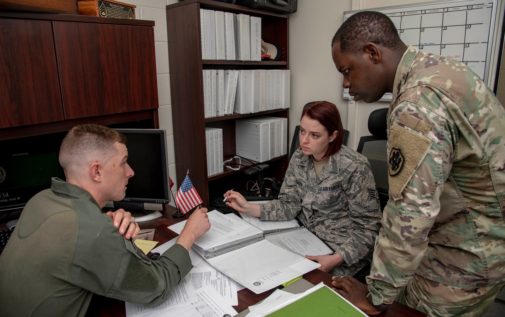 U.S. Air Force Staff Sgt. Vivian Johnson, AFMES Joint MWD Laboratory NCO in charge (left), discusses the upcoming Military Working Dog kennel inspection schedule with U.S. Army Staff Sgt. Joseph Tutt, AFMES Joint MWD laboratory manager (center), and U.S Navy Lt. Ken Lindsay, AFMES Joint MWD Laboratory chief, June 7, 2019. Johnson and Tutt conduct random inspections each month to ensure training aids for the MWDs are being handled correctly and those handling them have the proper authorization. (U.S. Air Force photo by Staff Sgt. Nicole Leidholm)