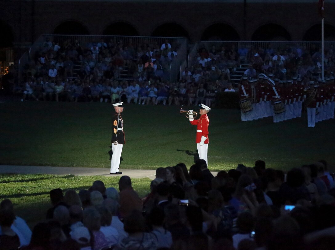 Sergeant Maj. Adrian L. Tagliere, barracks sergeant major, and Cpl. Teal Ewer, ceremonial bugler, perform during a Friday Evening Parade at Marine Barracks Washington, D.C., July 5, 2019. General Robert B. Neller, commandant of the Marine Corps, was the hosting official and the guest of honor was The Honorable Mr. Michael R. Pompeo, U.S. Secretary of State. (U.S. Marine Corps photo by Sgt. Robert Knapp)