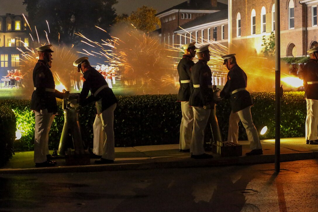 Body Bearers with Bravo Company fire cannons during a Friday Evening Parade at Marine Barracks Washington, D.C., July 5, 2019. General Robert B. Neller, commandant of the Marine Corps, was the hosting official and the guest of honor was The Honorable Mr. Michael R. Pompeo, U.S. Secretary of State. (U.S. Marine Corps photo by Pfc. Allen Sanders)
