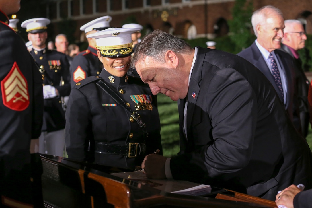 The Honorable Mr. Michael R. Pompeo, U.S. Secretary of State, signs the official guestbook after a Friday Evening Parade at Marine Barracks Washington, D.C., July 5, 2019. General Robert B. Neller, commandant of the Marine Corps, was the hosting official and the guest of honor was The Honorable Mr. Michael R. Pompeo, U.S. Secretary of State. (U.S. Marine Corps photo by Pfc. Allen Sanders)