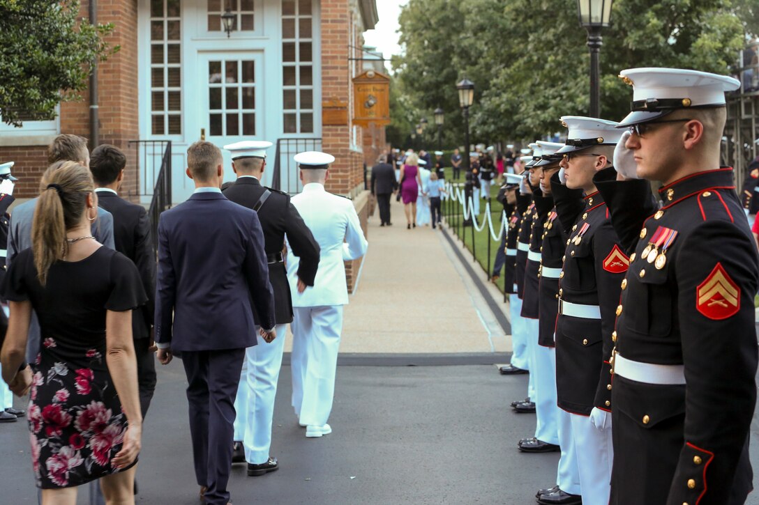Marines with H&S Company salute the official reception party during a Friday Evening Parade at Marine Barracks Washington, D.C., July 5, 2019. General Robert B. Neller, commandant of the Marine Corps, was the hosting official and the guest of honor was The Honorable Mr. Michael R. Pompeo, U.S. Secretary of State. (U.S. Marine Corps photo by Pfc. Allen Sanders)