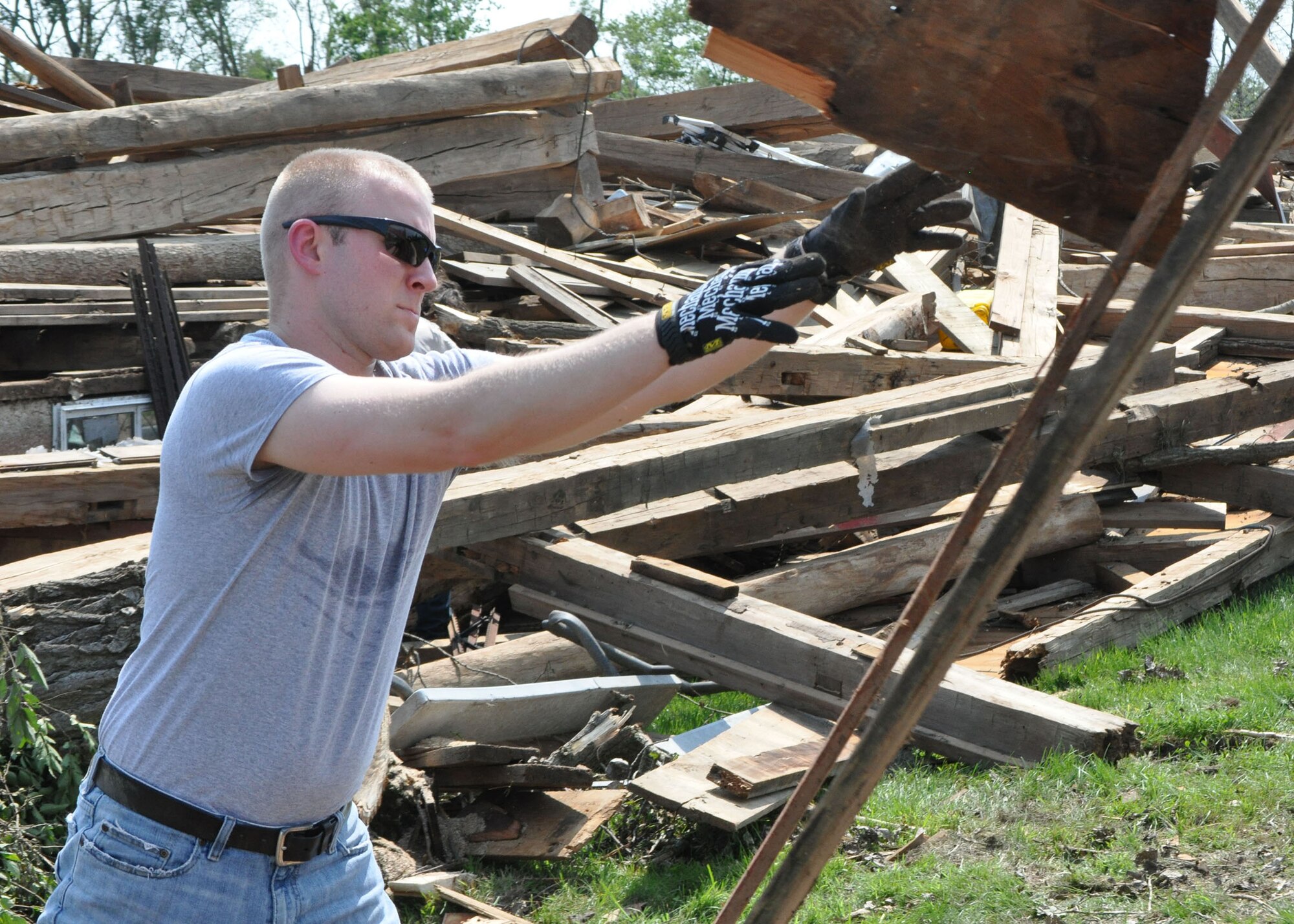 Tech. Sgt. Jonathan Porter, 445th Logistics Readiness Squadron, clears away debris while helping with disaster relief efforts June 1, 2019. Nearly a dozen Airmen from the 445th Airlift Wing living at Wright-Patterson Air Force Base and surrounding communities experienced damage to their property after tornados hit the area May 27, 2019.