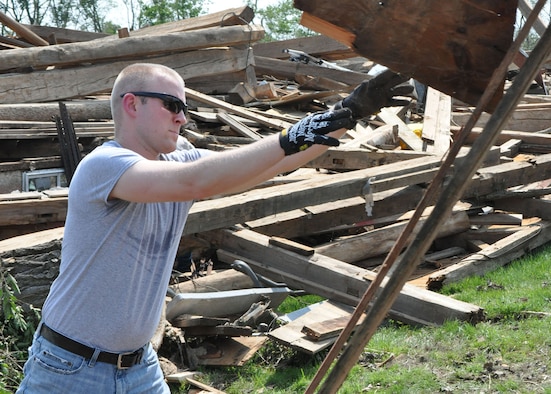 Tech. Sgt. Jonathan Porter, 445th Logistics Readiness Squadron, clears away debris while helping with disaster relief efforts June 1, 2019. Nearly a dozen Airmen from the 445th Airlift Wing living at Wright-Patterson Air Force Base and surrounding communities experienced damage to their property after tornados hit the area May 27, 2019.