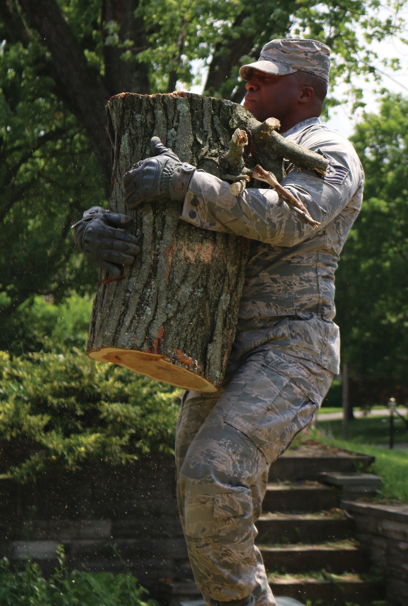 Tech. Sgt. Jason Thomas, 445th Aerospace Medicine Squadron medical technician, carries part of a tree that was cut into pieces as part of the tornado cleanup effort June 1, 2019. Nine Airmen from the 445th AMDS were helping one of their own who’s home was heavily damaged after several tornadoes hit the Miami Valley area May 27, 2019