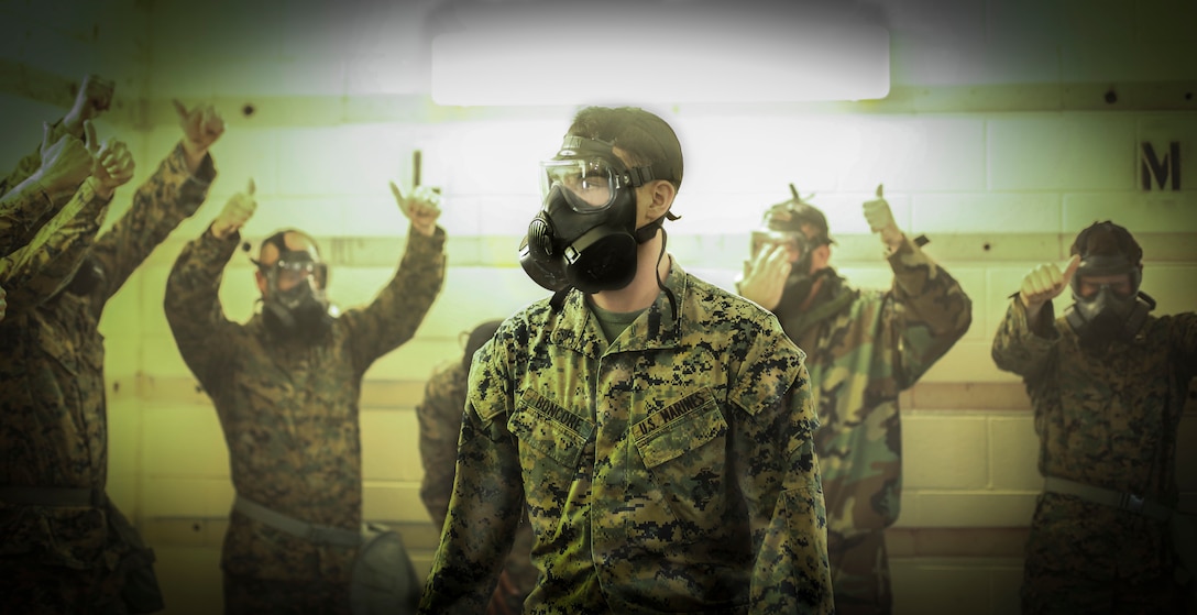 U.S. Marine James Boncore, a chemical, biological, radiological and nuclear defense specialist, with 2nd Air Naval Gunfire Liaison Company, II Marine Expeditionary Force Information Group, burns chlorobenzalmalononitrile tablets during a gas chamber training event at Camp Lejeune, N.C., July 2, 2019.  Gas chamber training consists of Marines being exposed to chlorobenzalmalononitrile tablets, commonly known as CS gas, in order to familiarize themselves with their M50 gas mask.