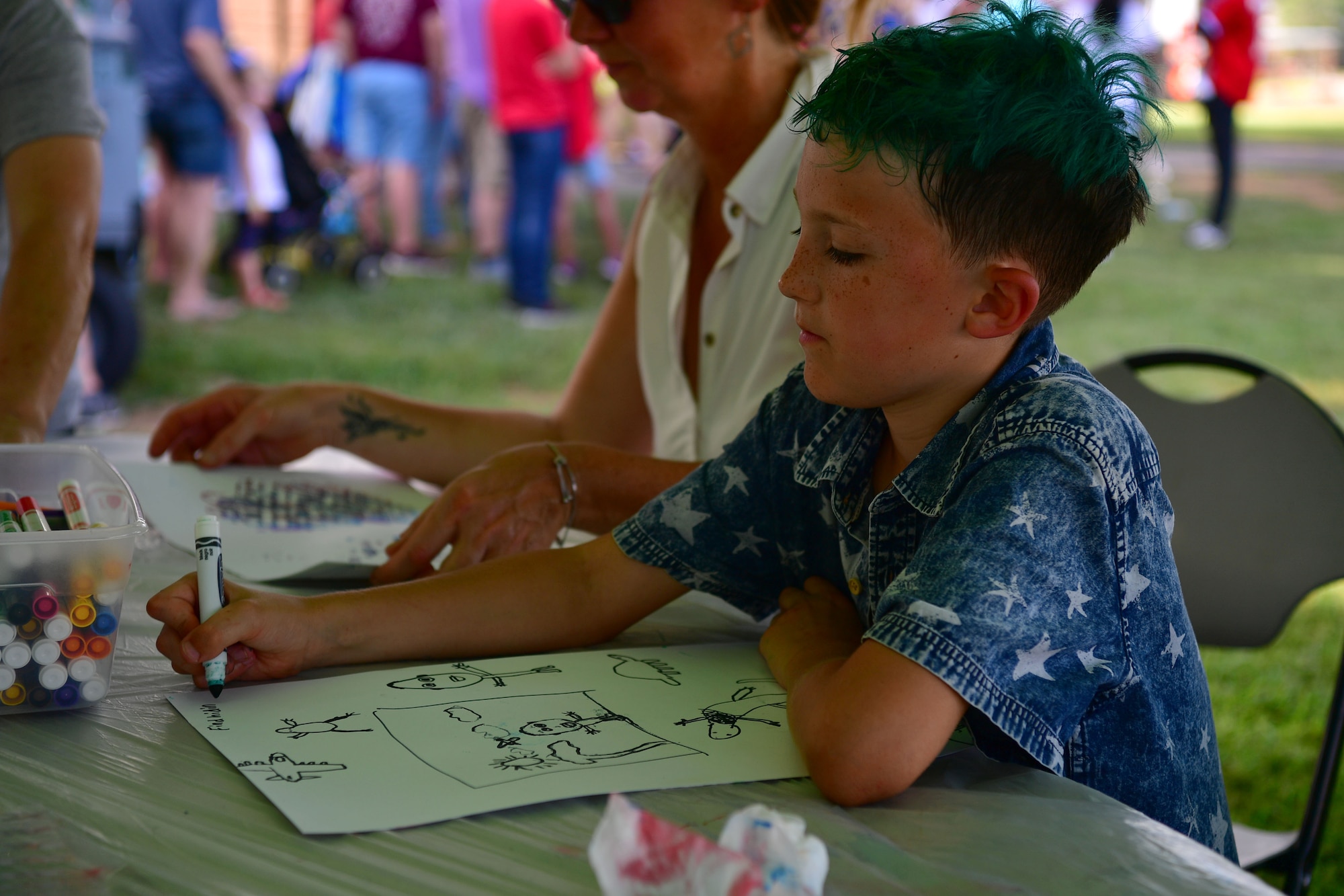 A child colors a picture during the Liberty Fest.