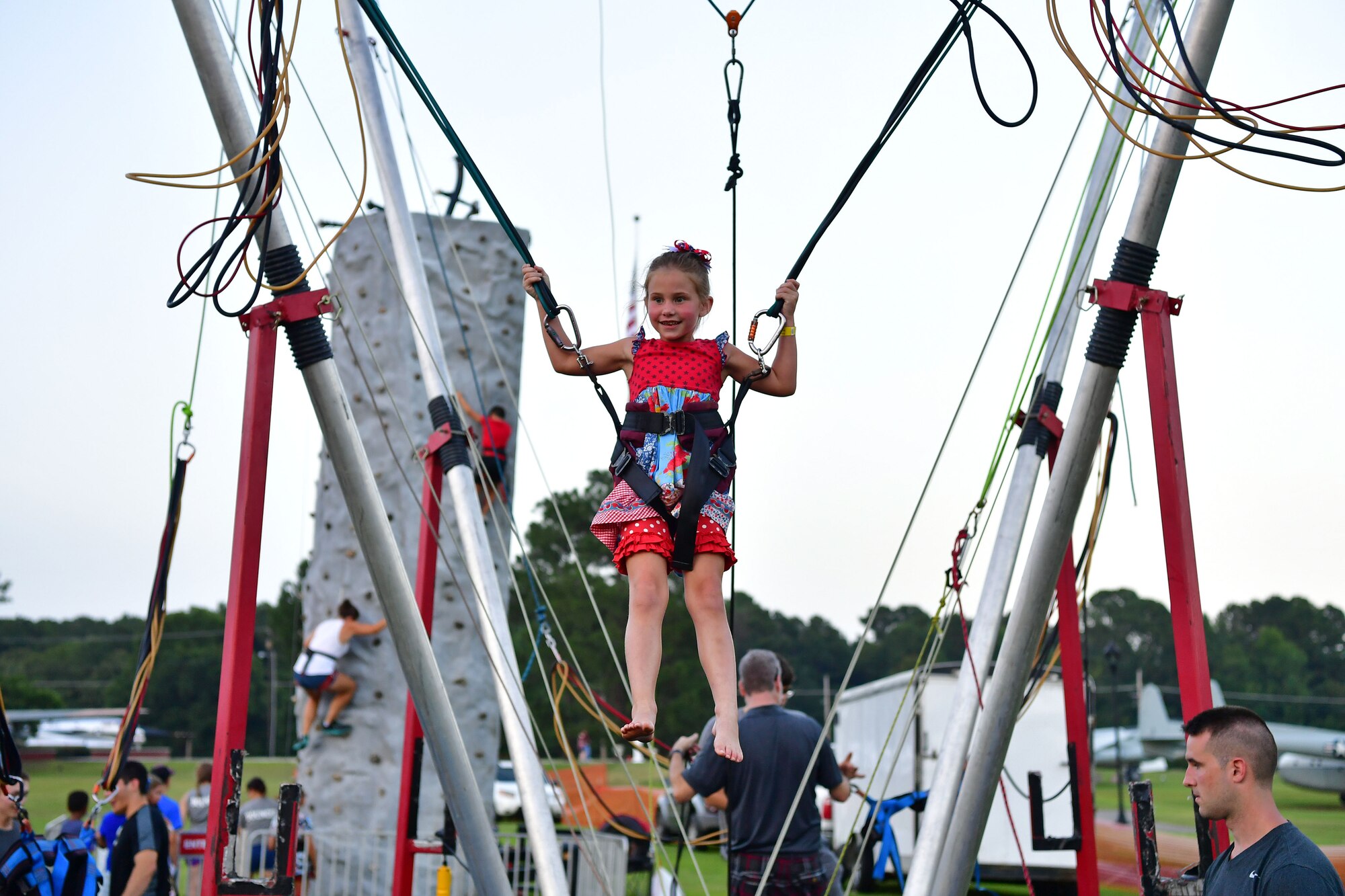 A child bounces on a bungee jumper.