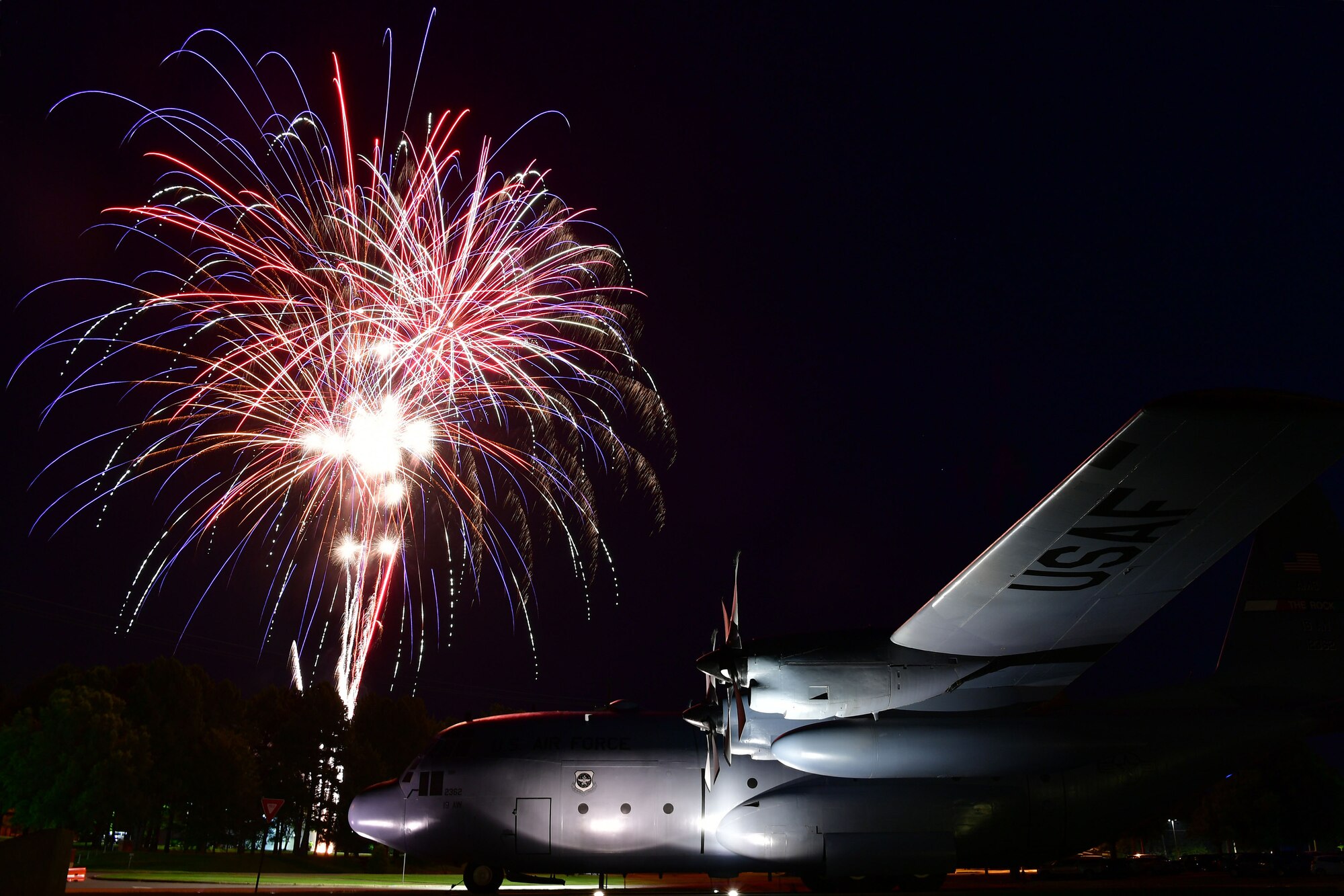 Fireworks go off over a C-130H during liberty fest