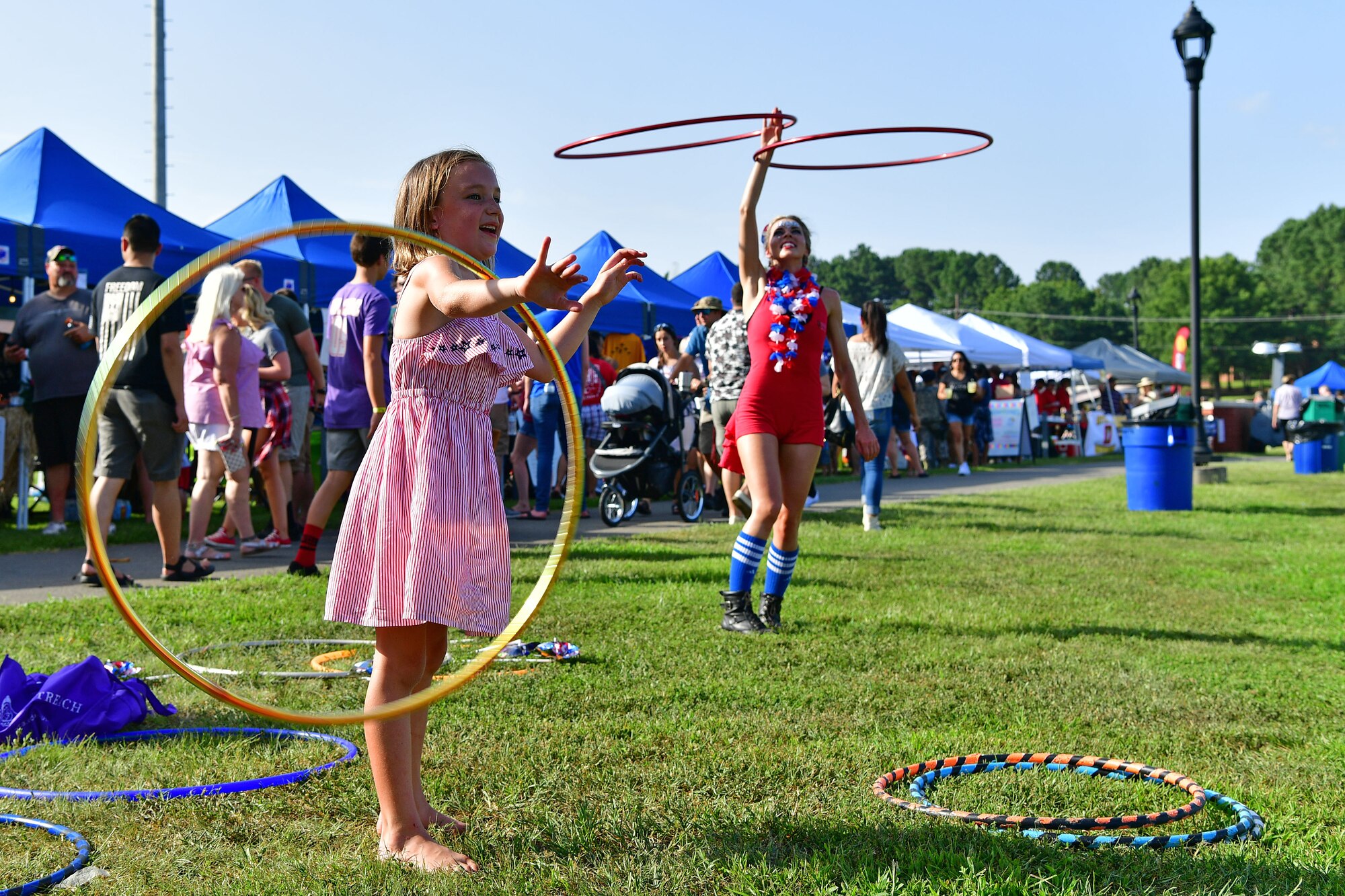 A child twirls a hula hoop during the liberty fest