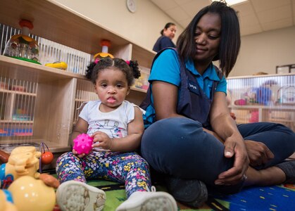 Tonya Smith, 502nd Force Support Squadron, child development program lead technician, plays games with toddlers June 11 at the Gateway Child Development Center, Joint Base San Antonio-Lackland. The CDCs focus on creating a positive, social, and emotional experience as part of their goal towards safe and nurturing environment.