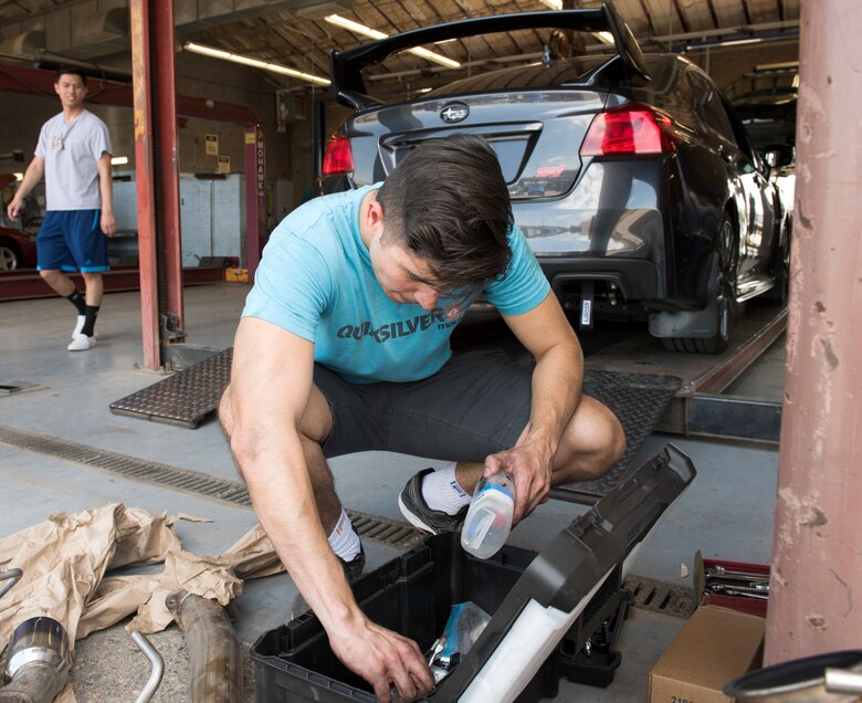 Senior Airman Igor Pacheco, 56th Medical Support Squadron lab technician, shuffles through a tool box while replacing an exhaust system on his 2018 Subaru June 29, 2019, in the Auto Hobby Shop at Luke Air Force Base, Ariz.