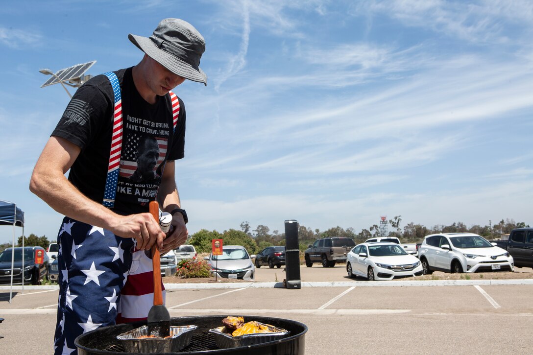 Cpl. Landon Blood, a Bulk Fuel Specialist with Headquarters and Headquarters Squadron (H&HS), prepares lunch for the H&HS Barbecue Cook-off at Marine Corps Air Station Miramar, Calif., Jul. 3. The H&HS Barbecue Cook-off was held this month in order to build unit cohesion and boost morale throughout the squadron. (U.S. Marine Corps photo by LCpl. Andrew Hiatt)