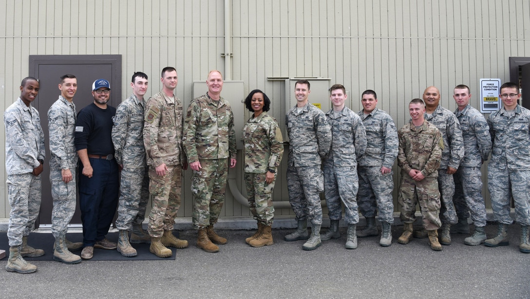 Col. Michael Hough, 30th Space Wing commander, and Chief Master Sgt. Diena Mosely, 30th Space Wing command chief, take a group photo with 12 Airmen from the 30th Civil Engineer Squadron March 12, 2019, at Vandenberg Air Force Base, Calif. After a storm hit Vandenberg AFB on March 8, 2019, Hough and Mosely visited to the 30th CES to thank each Airmen who worked long, tedious hours during the storm. (U.S. Air Force photo by Airman 1st Class Aubree Milks)