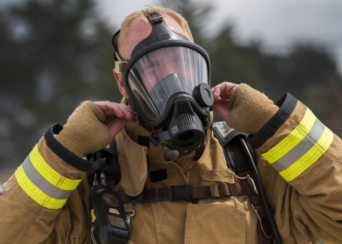 Col. Michael Hough, 30th Space Wing commander, tightens the straps on his respirator during a fire training exercise with the 30th Civil Engineer Squadron Fire Department March 21, 2019, at Vandenberg Air Force Base, Calif. Hough embedded with the 30th CES during an exercise to see firsthand what his Airmen do each and every day. (U.S. Air Force photo by Senior Airman Clayton Wear)