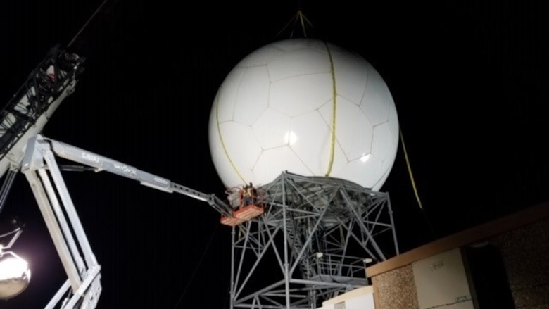 Contractors with Telecommunication Support Services Solutions, Inc., based in Florida, install a radome on a Weather Surveillance Doppler radar overnight Feb. 17, at Cannon Air Force Base, New Mexico. The company is on contract as part Program Executive Office Digital’s effort to support and sustain 25 radars owned by the U.S. Air Force. These 25 radars are one portion of more than 180 U.S. government-owned radars, called the NEXRAD system, which provides weather forecasts to the military, Federal Aviation Administration and National Weather Service. (Photo courtesy of Telecommunication Support Services Solutions)