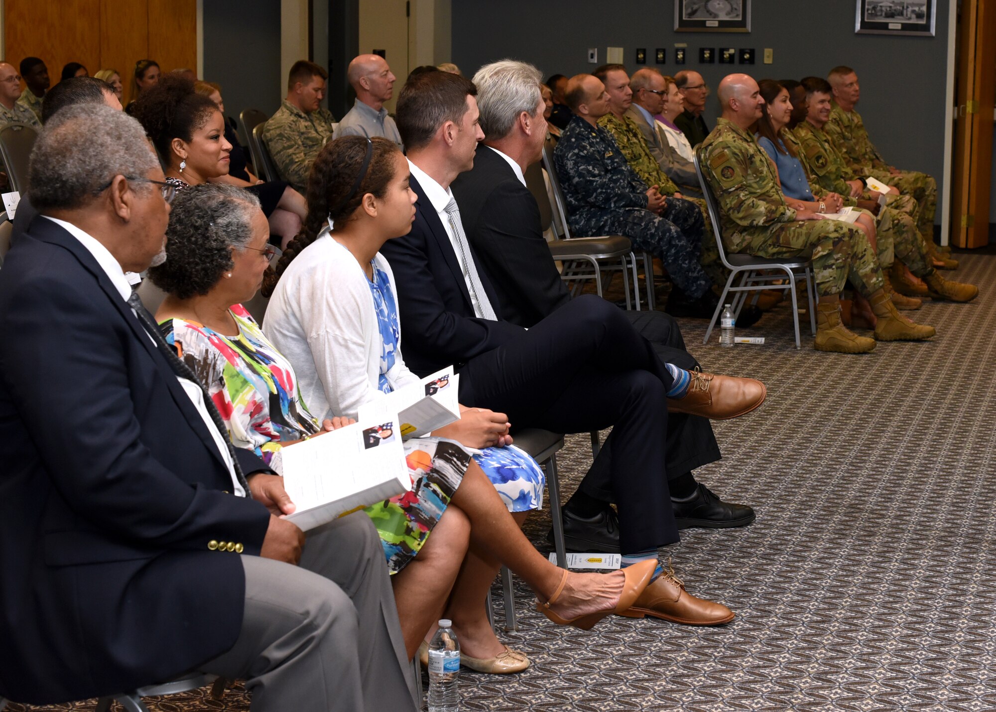 The departing and incoming commanders’ family members, San Angelo community leaders, and Goodfellow military and civilian personnel listen to the presiding remarks presented by Col. Andres Nazario, 17th Training Wing commander during the 17th Medical Group Change of Command Ceremony at the event center on Goodfellow Air Force Base, Texas, July 8, 2019. A change of command ceremony is a military tradition, which illustrates the formal transfer of authority by the passing the guidon from departing commander to incoming commander. (U.S. Air Force photo by Airman 1st Class Abbey Rieves/Released)