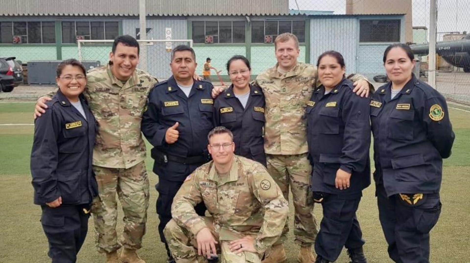 Sgt. 1st Class Hector Guillen (left), Sgt. Brad Miller (bottom middle), and Master Sgt. Evan McDonough (right) pose for a photo with members of the Peruvian National Police July 2, 2019, in Lima, Peru. Members of the WVARNG trained more than 120 members of the Peruvian Armed Forces and the Peruvian National Police on a variety of aeromedical topics during a week-long subject matter exchange. (Courtesy photo)