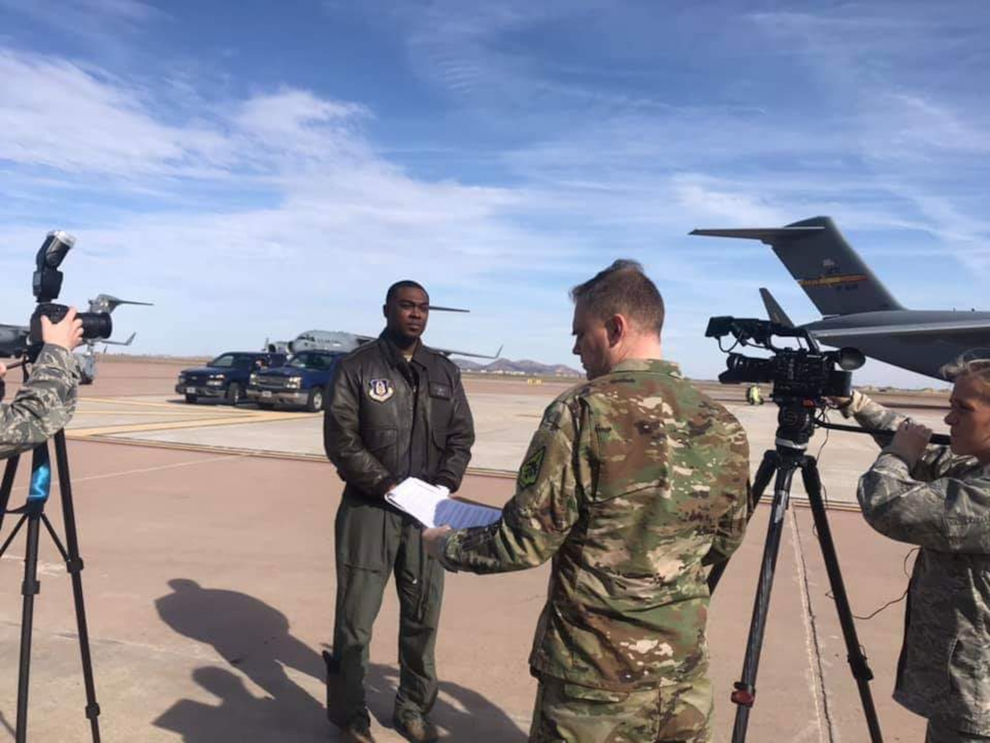 Maj. Jon Quinlan (right center) conducts a video interview for the 507th Air Refueling Wing public affairs office prior to a KC-46A arrival ceremony, Feb. 8, 2019.  Quinlan served as the chief of public affairs for the 507 ARW from Nov. 2012 to July 2019.  (U.S. Air Force Photo by Lauren Gleason)