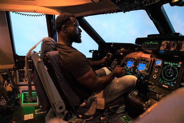 Actor, Michael James Shaw sits in the cockpit of a C-5M Simulator during a tour of the 433rd Airlift Wing, Joint Base San Antonio, Texas June 28, 2019.