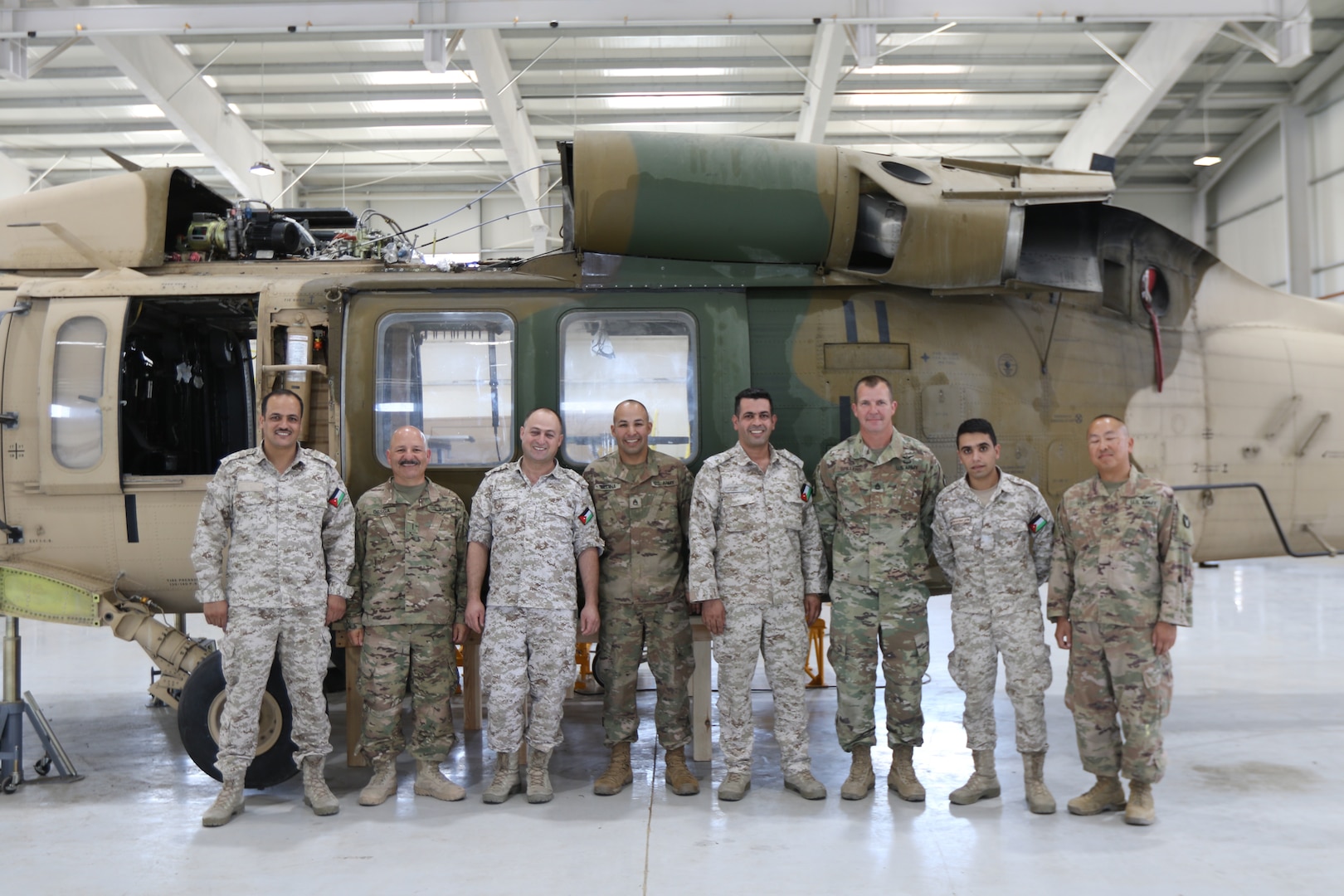 U. S. Army Soldiers and Royal Jordanian Air Force members gather for a photo while conducting an aviation subject matter exchange in Amman, Jordan, June 19, 2019. (U.S. Army National Guard photo by Staff Sgt. Veronica McNabb)
