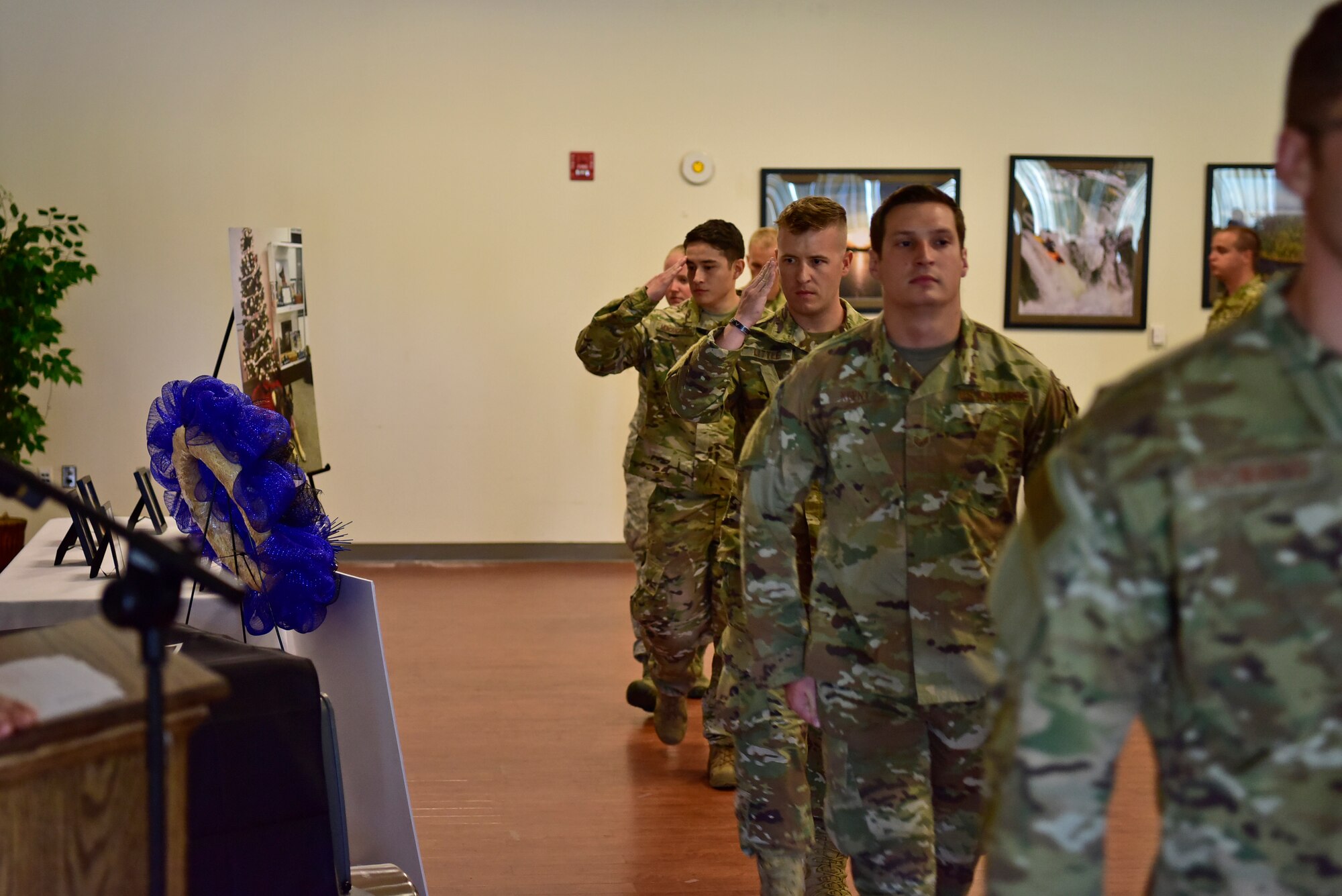 Members of the 11th Security Forces Squadron salute as they walk past a memorial for Military Working Dog, Tommy, during a memorial ceremony at the Community Commons on Joint Base Andrews, Md., July 3, 2019. JBA has 27 dogs in their kennels ranging from explosive detection to narcotics and patrol. (U.S. Air Force photo by Airman 1st Class Noah Sudolcan)