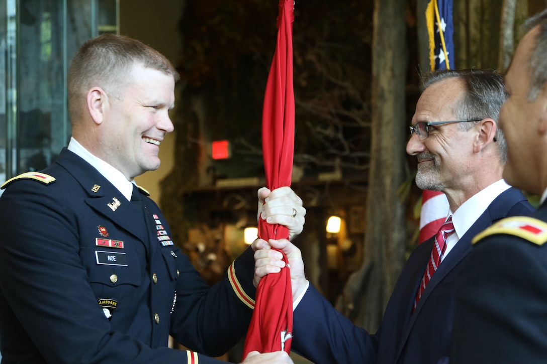 Col. Eric Noe (right) returns the Army Corps of Engineers flag to Craig Pierce, Deputy District Engineer for programs and project management of the Corps’ Little Rock District, during the district change of command ceremony.