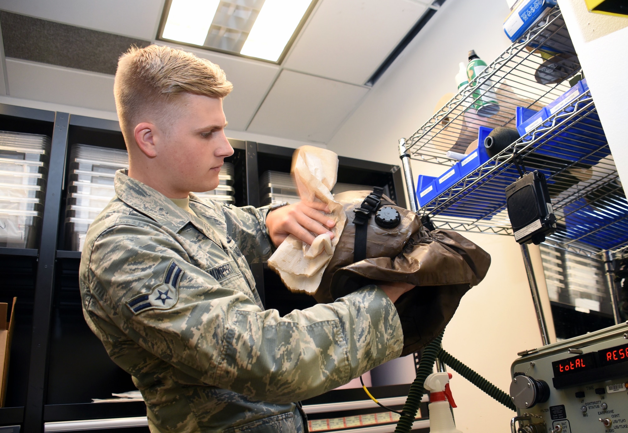 U.S. Air Force Airman 1st Class Joshua Humpert, 437th Operations Support Squadron Aircrew Flight Equipment technician, inspects aircrew flight equipment July 9, 2019, at Travis Air Force Base, California. Humpert accepted a temporary duty at Travis in order to experience the AFE mission through the lens of another base outside his home station of Joint Base Charleston, South Carolina. (U.S. Air Force photo by Senior Airman Christian Conrad)