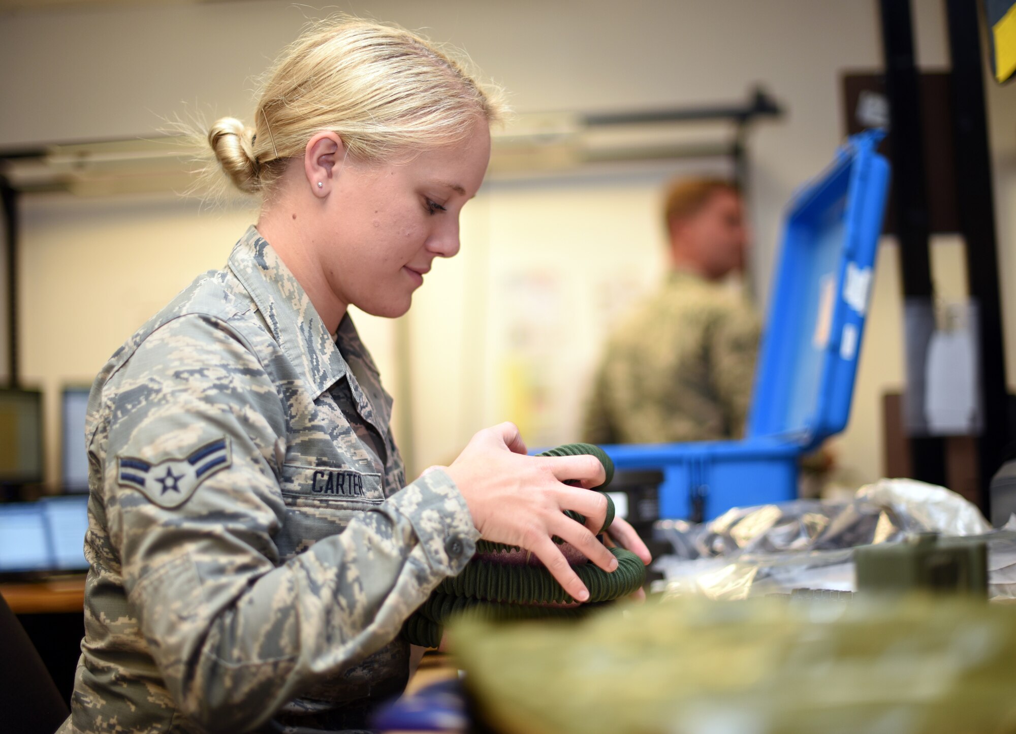 U.S. Air Force Airman 1st Class Hailey Carter, 60th Operations Support Squadron Aircrew Flight Equipment technician, inspects aircrew equipment July 9, 2019, at Travis Air Force Base, California. Travis’ AFE flight works to keep aircrew flight equipment in good working condition thereby safeguarding aircrew personnel in the event of dangerous situations. (U.S. Air Force photo by Senior Airman Christian Conrad)