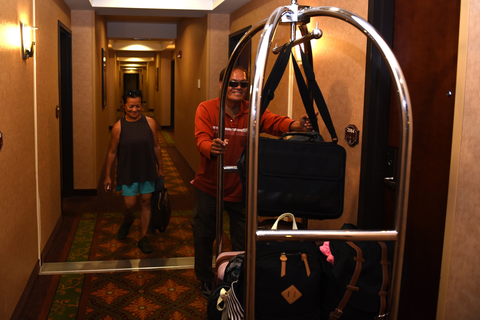 Jose and Angelita Peralta, West Westwind Inn guests, bring their luggage to their room July 8, 2019, at Travis Air Force Base, California. Westwind Inn is one of the finalists for the Air Force’s 2019 Innkeeper Award after being named the best in Air Mobility Command. The Innkeeper Award is an annual honor recognizing excellence in the service’s lodging operations. (U.S. Air Force photo by Airman 1st Class Cameron Otte)