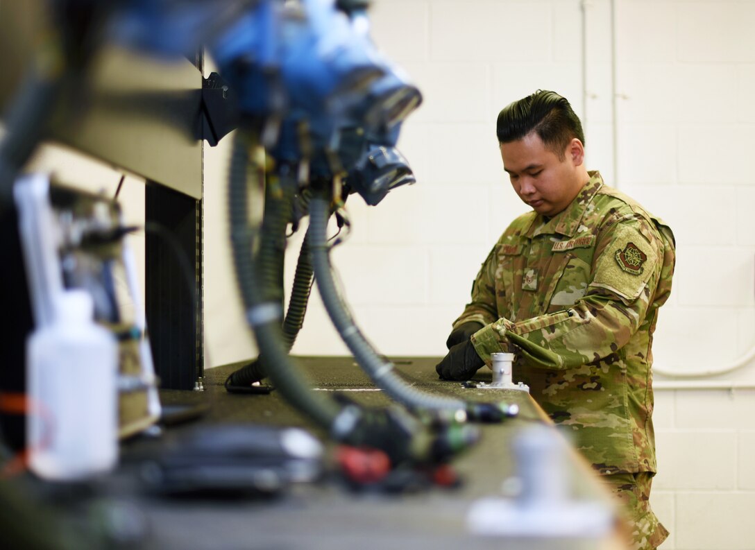 U.S. Air Force Staff Sgt. Kenny Pham, 60th Operations Support Squadron Aircrew Flight Equipment technician, inspects aircrew flight equipment July 9, 2019, at Travis Air Force Base, California. Travis’ AFE flight works to keep aircrew flight equipment in good working condition thereby safeguarding aircrew personnel in the event of dangerous situations. (U.S. Air Force photo by Senior Airman Christian Conrad)