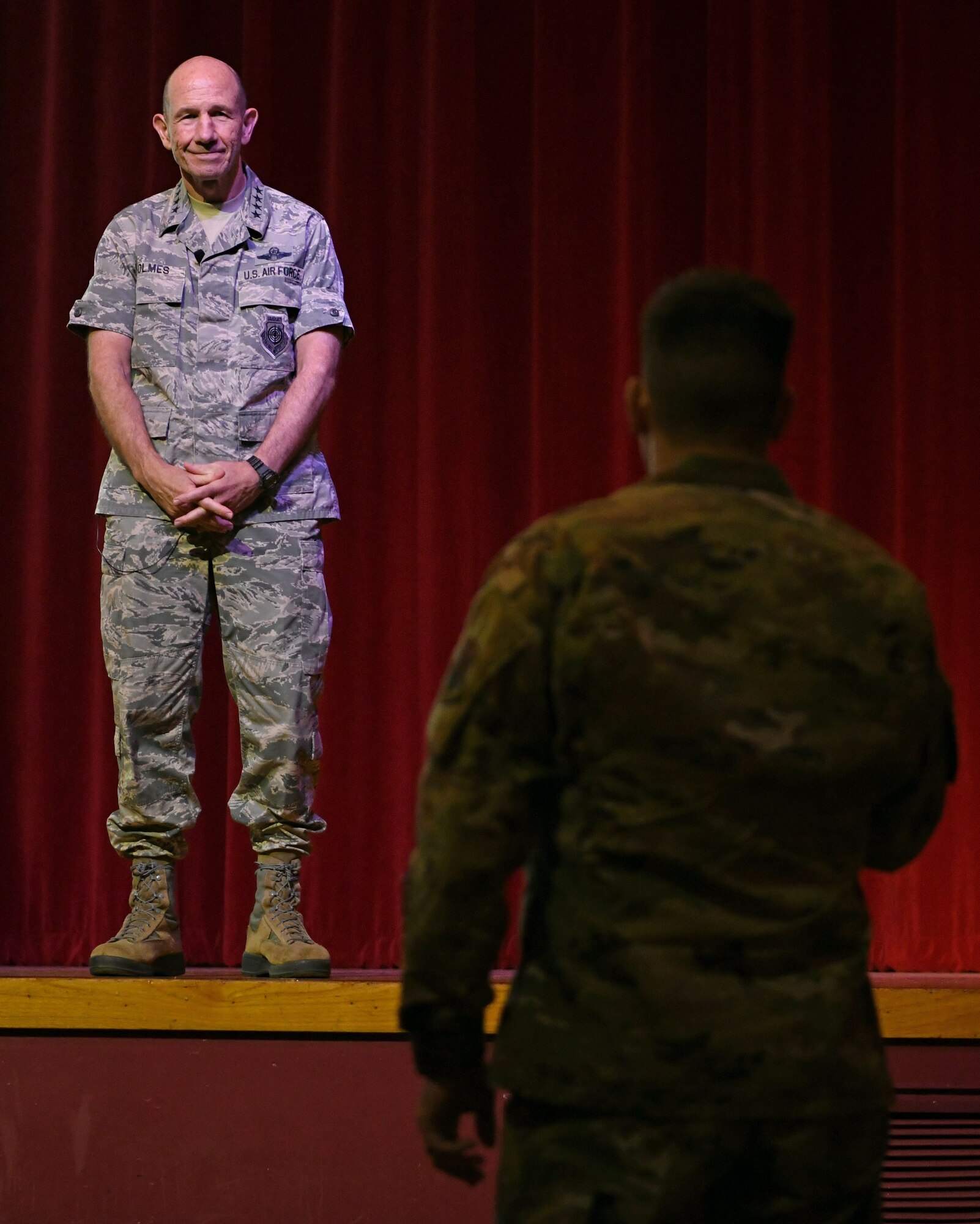 Photo of Gen. Mike Holmes, commander of Air Combat Command, discussing future 24th/25th Air Force merger at a town hall meeting.